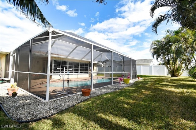 view of swimming pool with a lanai, a patio area, and a lawn