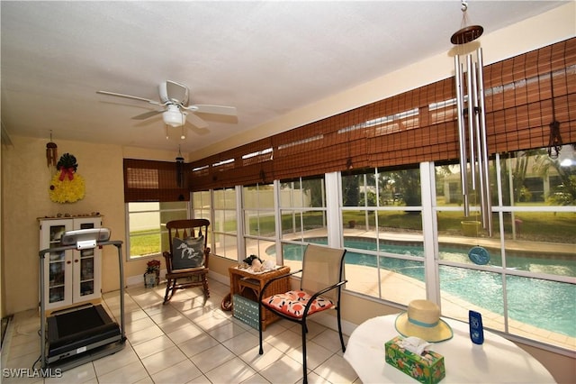 sunroom / solarium featuring ceiling fan