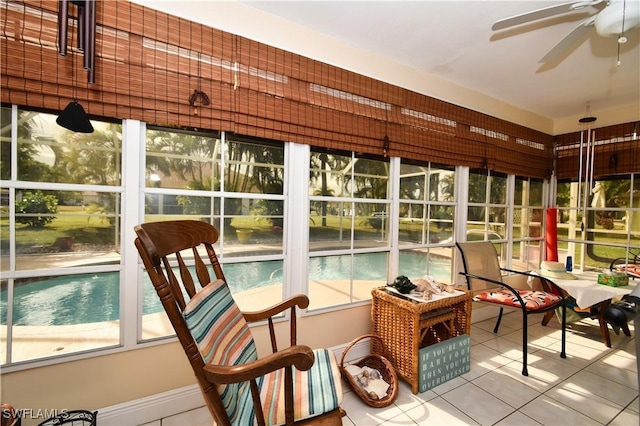 sunroom / solarium featuring ceiling fan