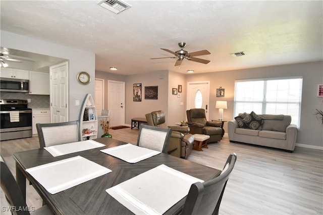 dining area featuring ceiling fan and light wood-type flooring