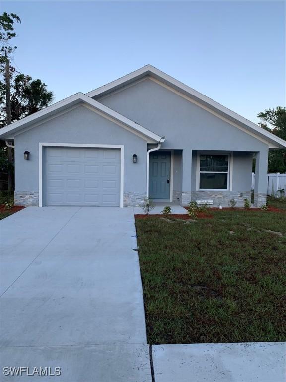 view of front of property with a front yard and a garage