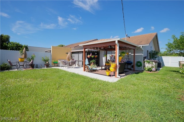 back of property featuring a patio area and a yard