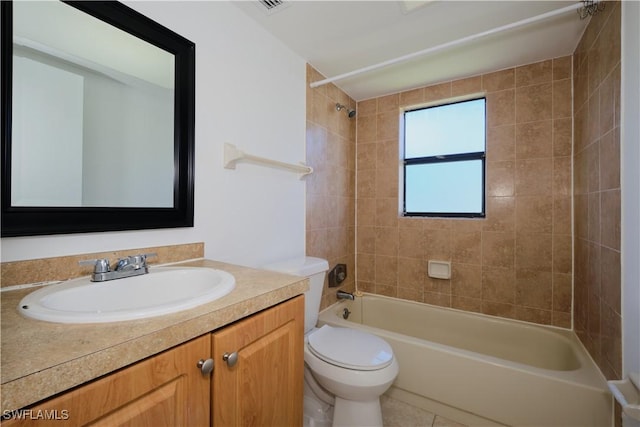 full bathroom with tile patterned flooring, vanity, toilet, and tiled shower / bath