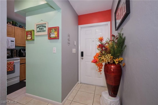 foyer entrance with light tile patterned floors