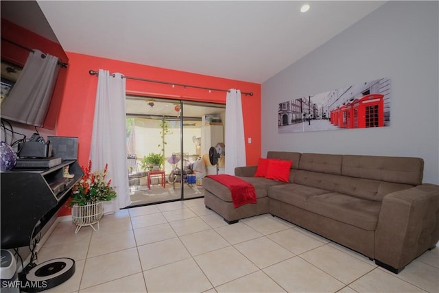 living room with light tile patterned flooring and vaulted ceiling