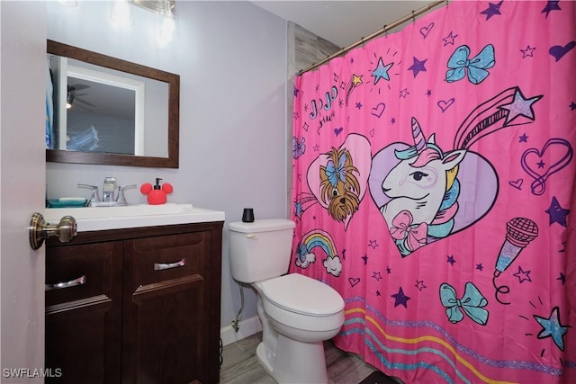 bathroom featuring a shower with curtain, vanity, hardwood / wood-style flooring, and toilet