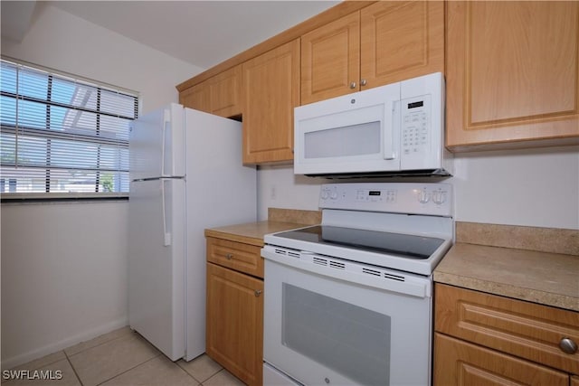 kitchen featuring light tile patterned floors and white appliances