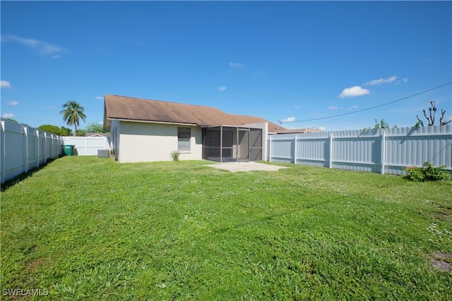 back of house with a yard and central air condition unit