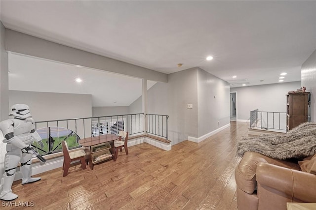 sitting room featuring lofted ceiling and light hardwood / wood-style flooring