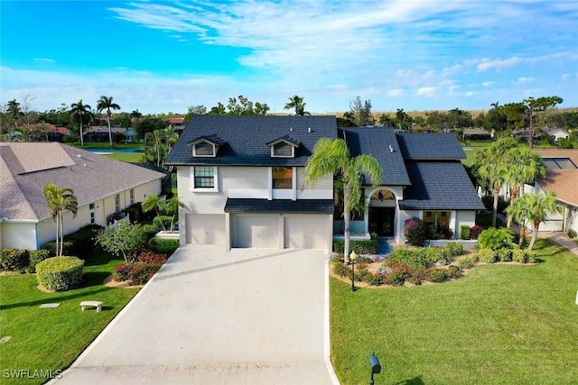 view of front of property with a front yard and a garage