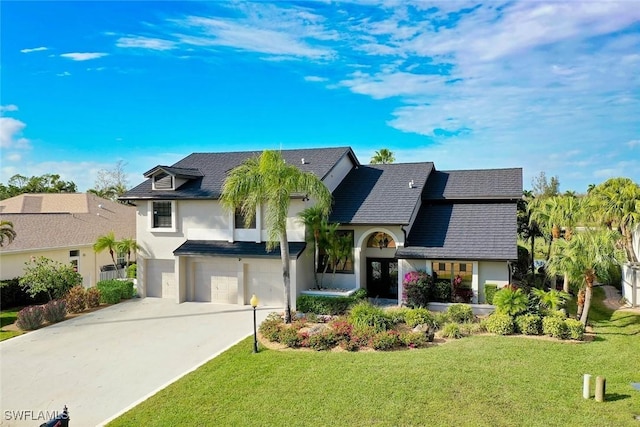 view of front facade with a front lawn and a garage