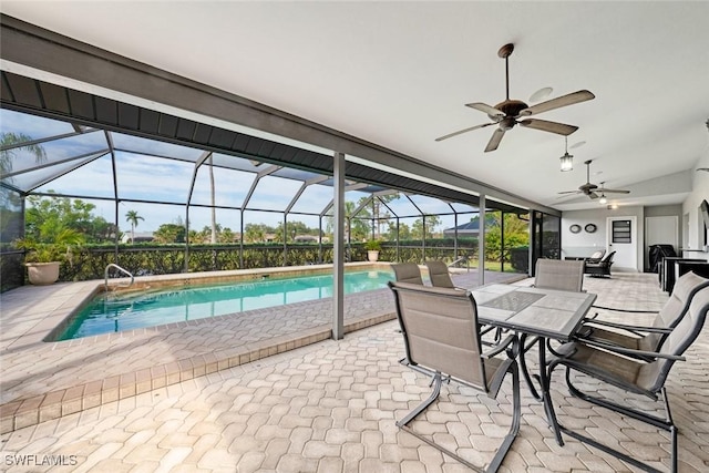 view of swimming pool with ceiling fan, a patio, and a lanai