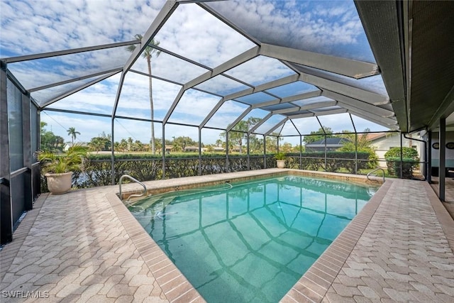 view of swimming pool featuring a lanai and a patio