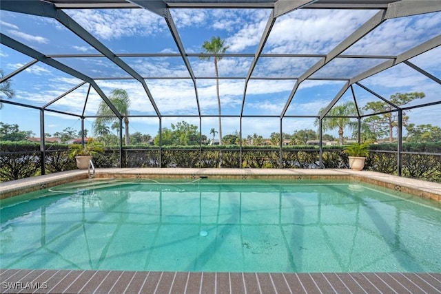 view of pool with glass enclosure