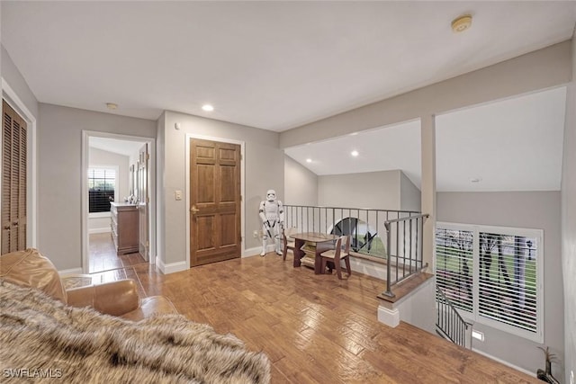 interior space featuring lofted ceiling and light wood-type flooring