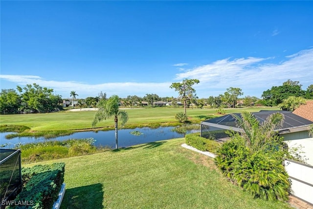 view of yard featuring a water view and glass enclosure