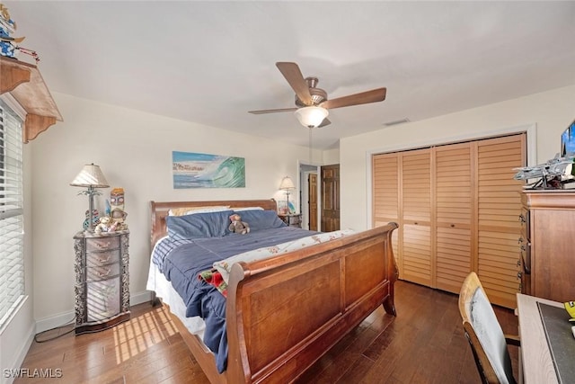 bedroom with ceiling fan, dark hardwood / wood-style floors, and a closet