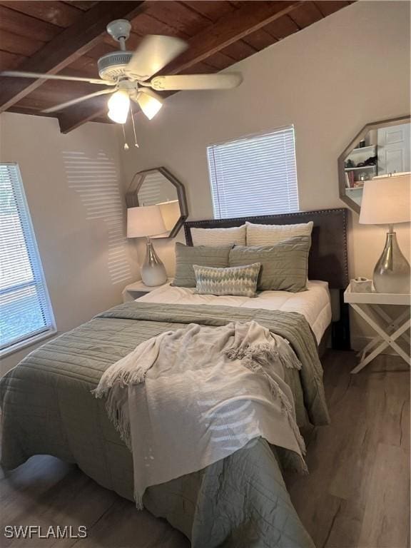 bedroom featuring beamed ceiling, hardwood / wood-style floors, ceiling fan, and wood ceiling