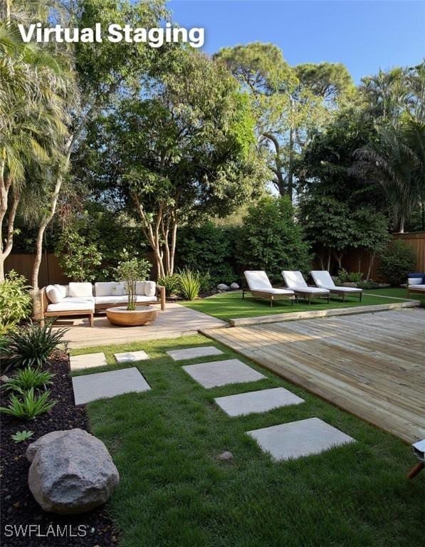 view of yard with a wooden deck and outdoor lounge area