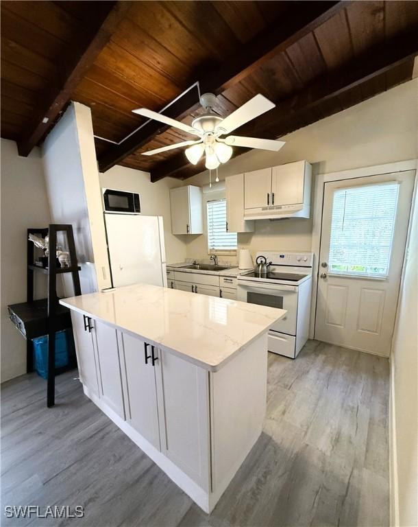 kitchen with white appliances, wooden ceiling, white cabinets, and a kitchen island