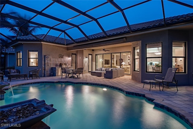 view of swimming pool featuring an outdoor living space, a patio, ceiling fan, and glass enclosure