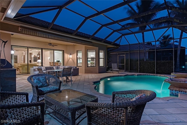 view of swimming pool with ceiling fan, a patio, a lanai, and pool water feature