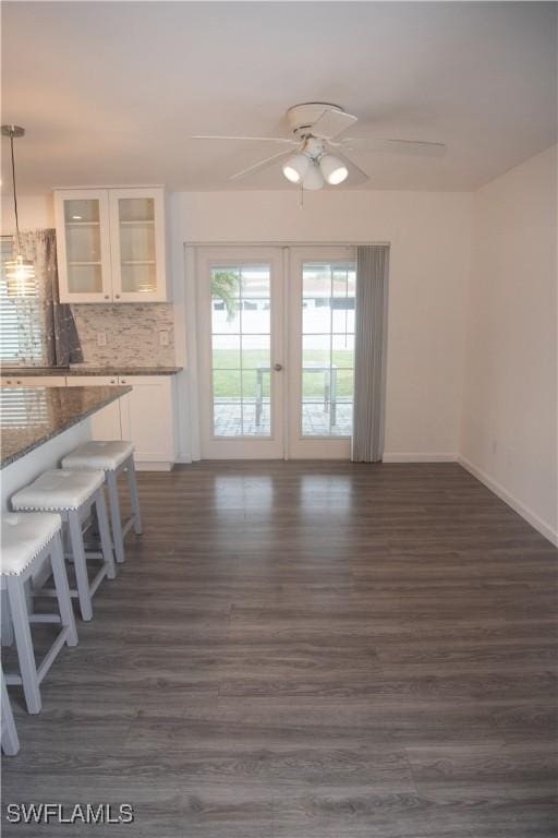 interior space with ceiling fan and dark hardwood / wood-style floors