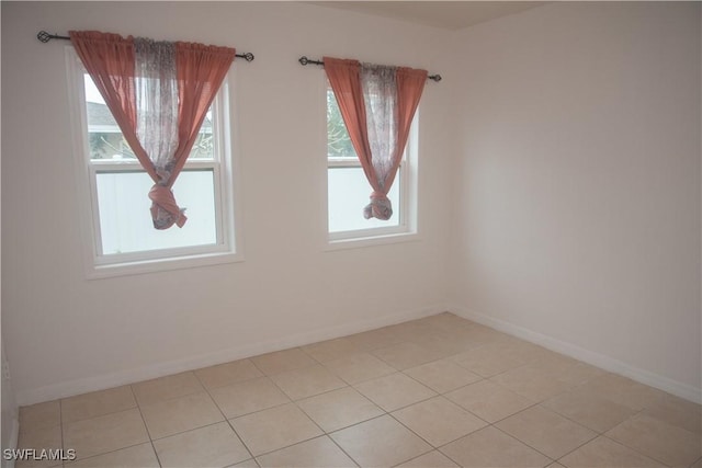 tiled spare room with a wealth of natural light