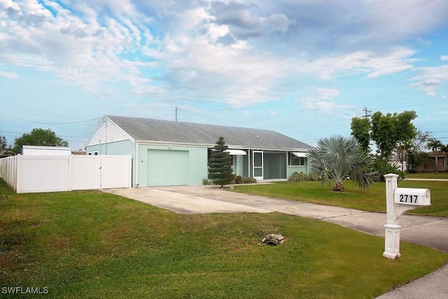 ranch-style home featuring a garage and a front yard