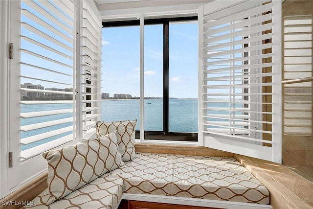 unfurnished sunroom featuring a water view and a healthy amount of sunlight