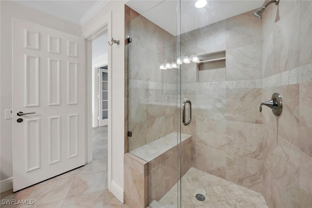 bathroom with a shower with door and crown molding