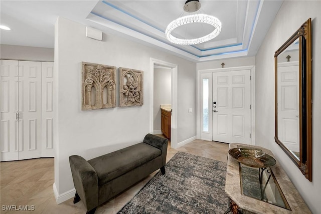 tiled foyer entrance featuring a raised ceiling