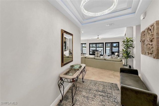 corridor featuring a tray ceiling