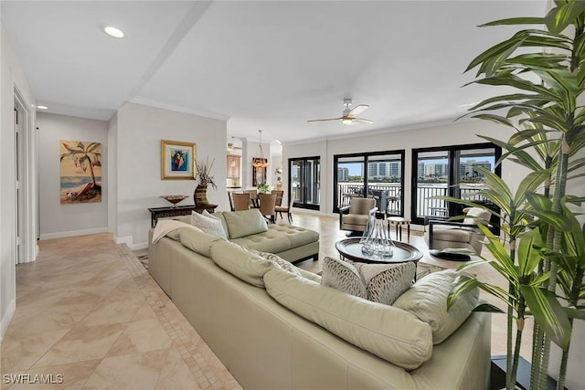 living room featuring ceiling fan and ornamental molding