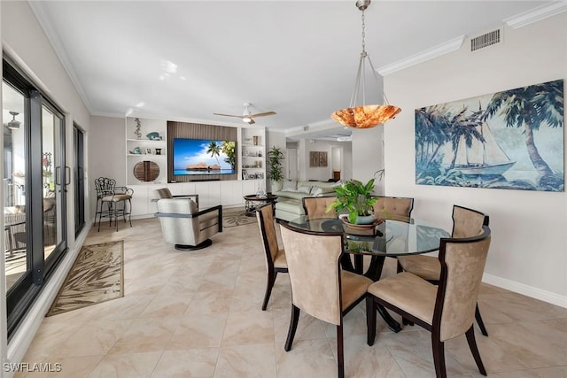 dining space with built in shelves, ceiling fan, and crown molding