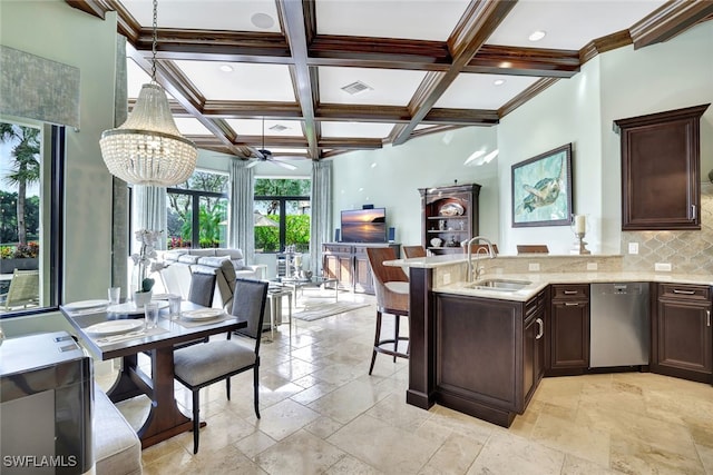 kitchen featuring a kitchen bar, coffered ceiling, stainless steel dishwasher, beam ceiling, and sink