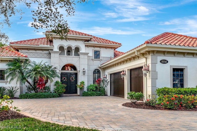 mediterranean / spanish home featuring french doors and a garage