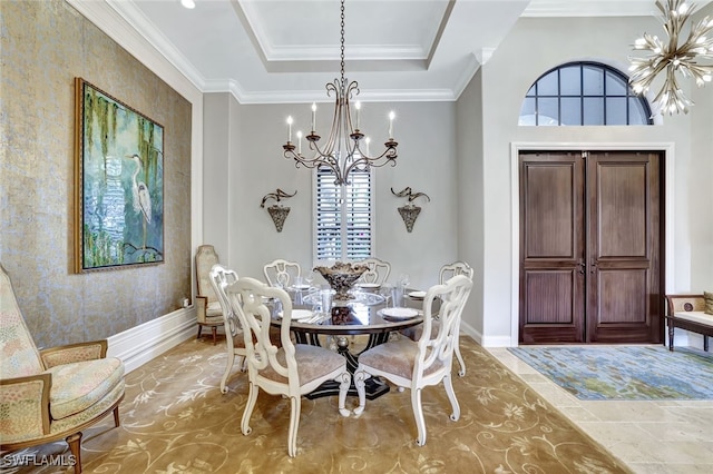 dining room with crown molding, a raised ceiling, and a chandelier