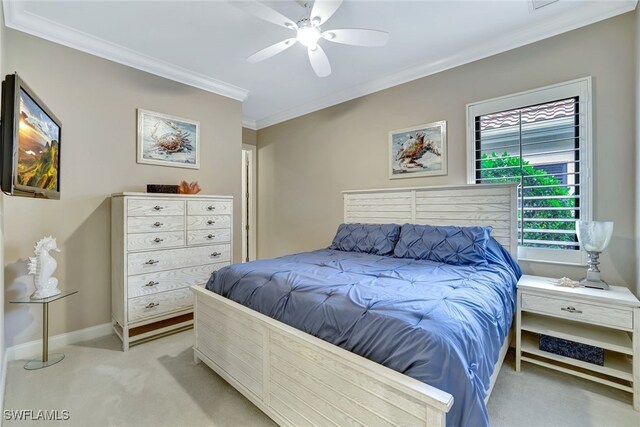 carpeted bedroom with ceiling fan and crown molding