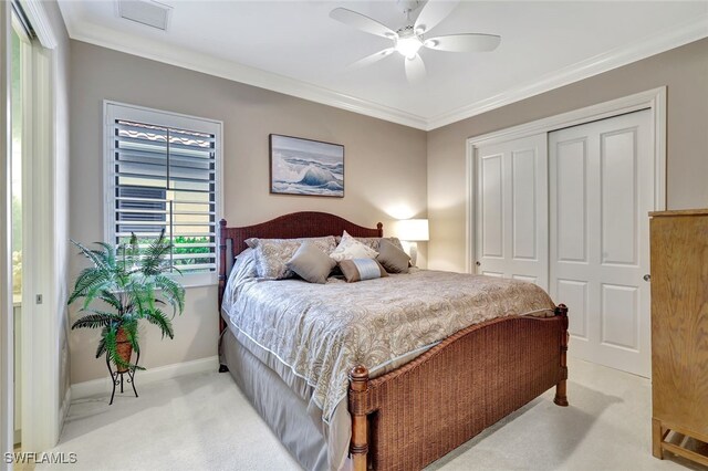 bedroom with ceiling fan, a closet, and ornamental molding