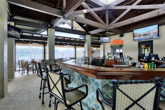 bar featuring lofted ceiling with beams