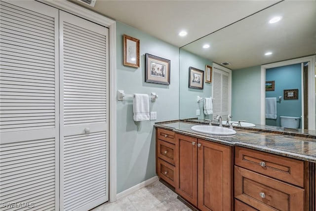 bathroom featuring vanity and toilet