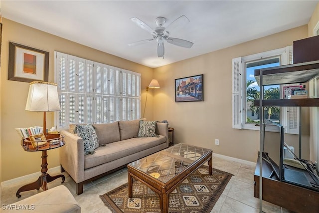 tiled living room featuring ceiling fan and plenty of natural light