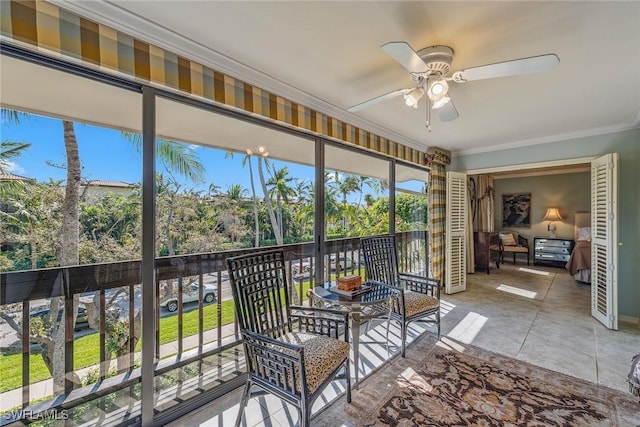 sunroom featuring ceiling fan