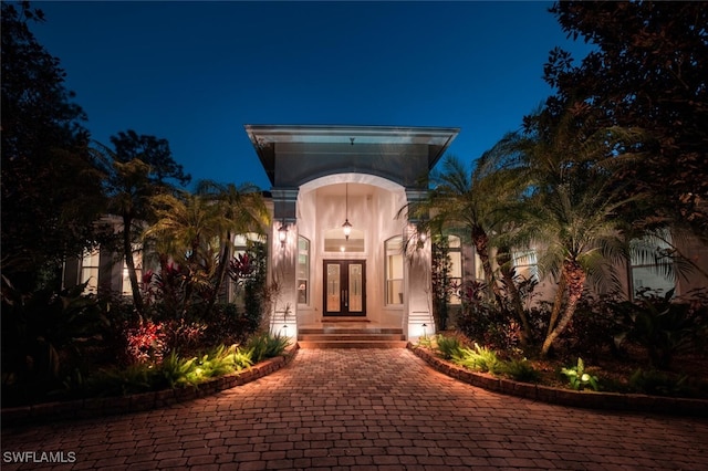 exterior entry at night featuring french doors