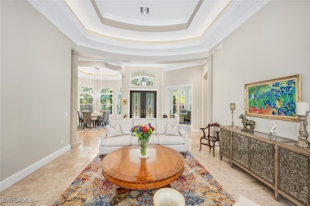 living room with a tray ceiling, crown molding, plenty of natural light, and french doors