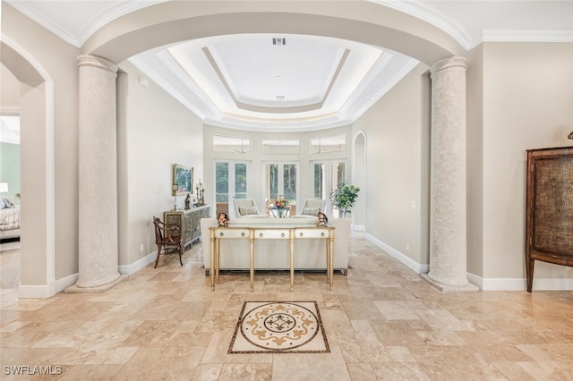 bathroom featuring a raised ceiling, crown molding, and decorative columns