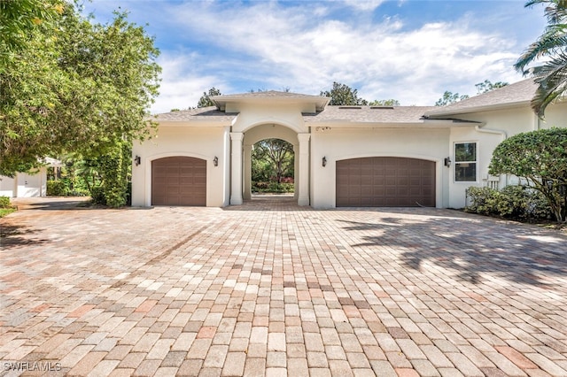 mediterranean / spanish-style house with a garage