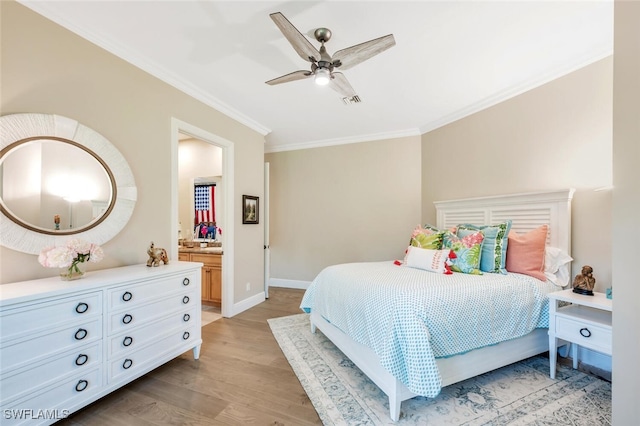 bedroom featuring ceiling fan, ornamental molding, connected bathroom, and light hardwood / wood-style flooring