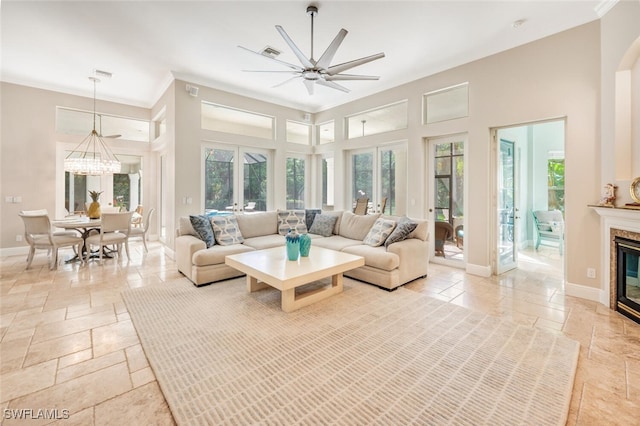 living room featuring french doors, ceiling fan, and a premium fireplace